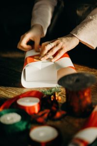 hand wrapping a small gift