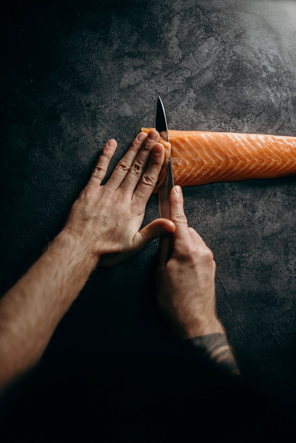 knife slicing salmon