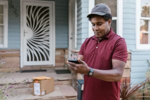 man standing outside the door making a call
