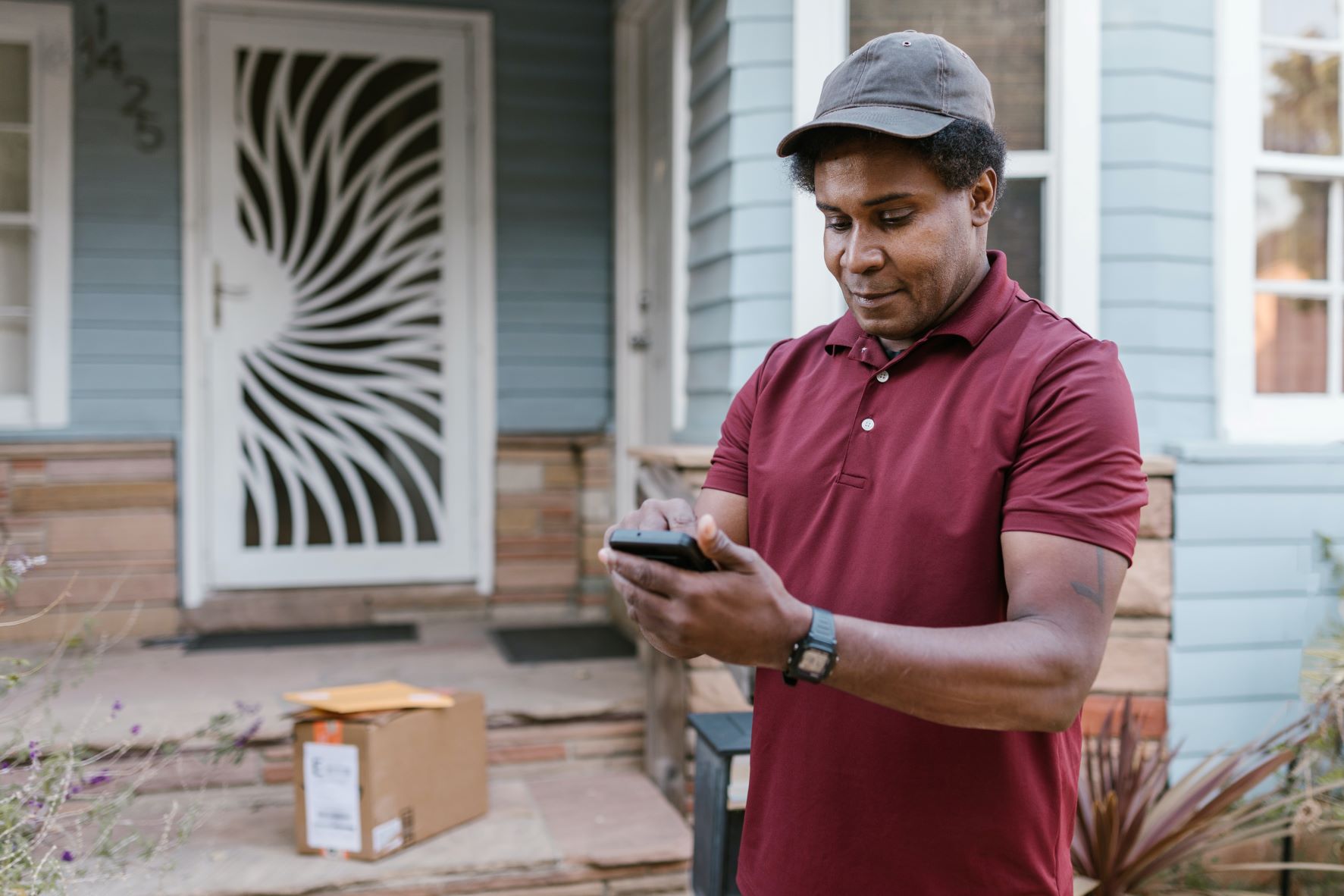 man standing outside the door making a call