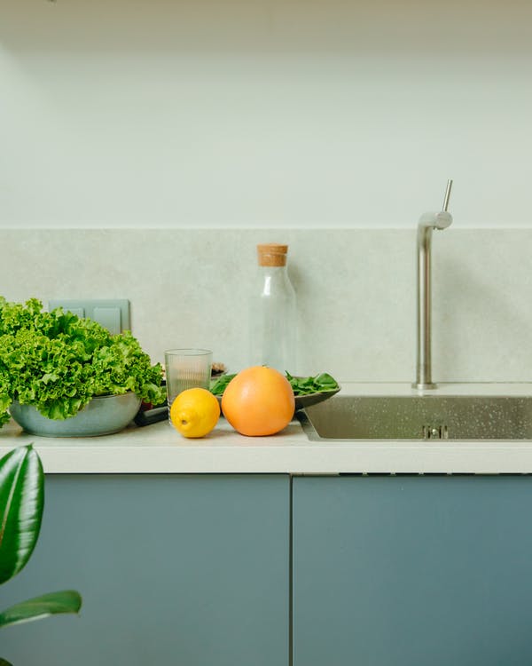 A semi-close up of a kitchen countertop with accessories.
