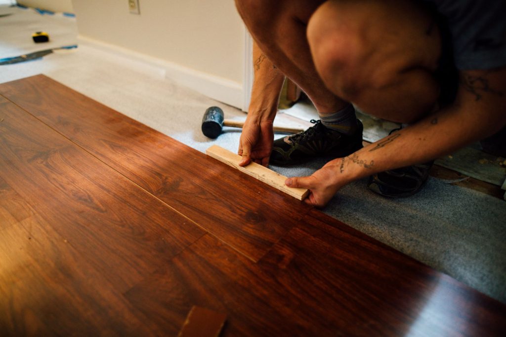 a photo of someone installing floor