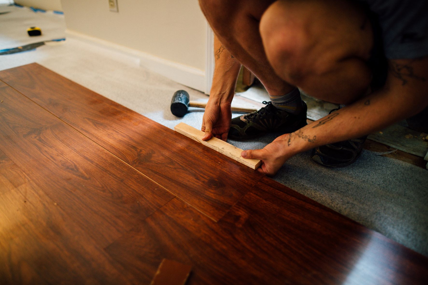 a photo of someone installing floor