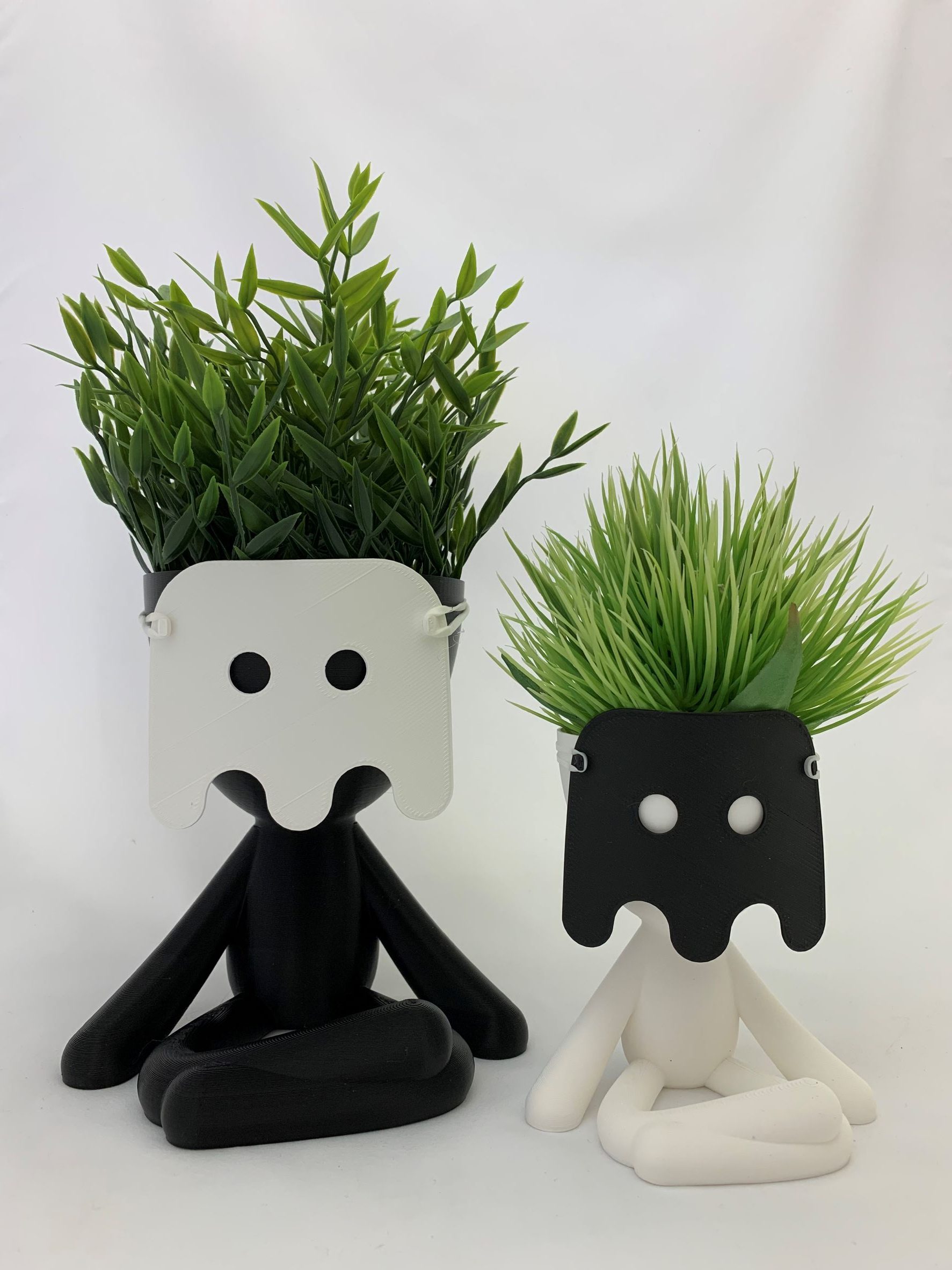 There are two Big Bob planter pots wearing masks.
