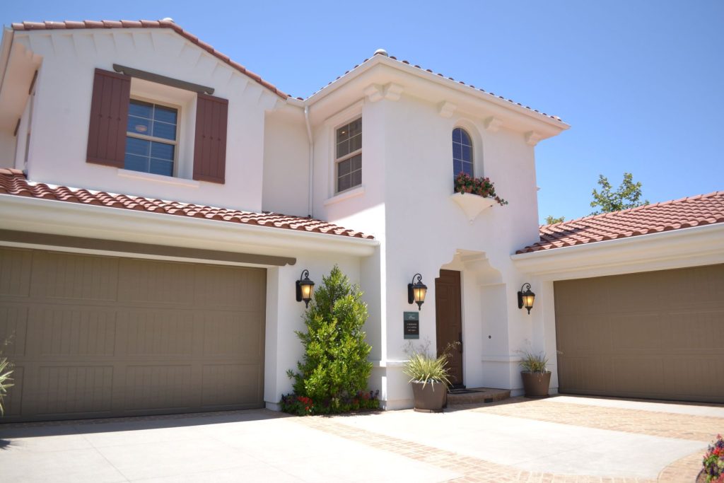 This is a picture of a white concrete two-story house.