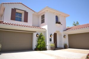 This is a picture of a white concrete two-story house.