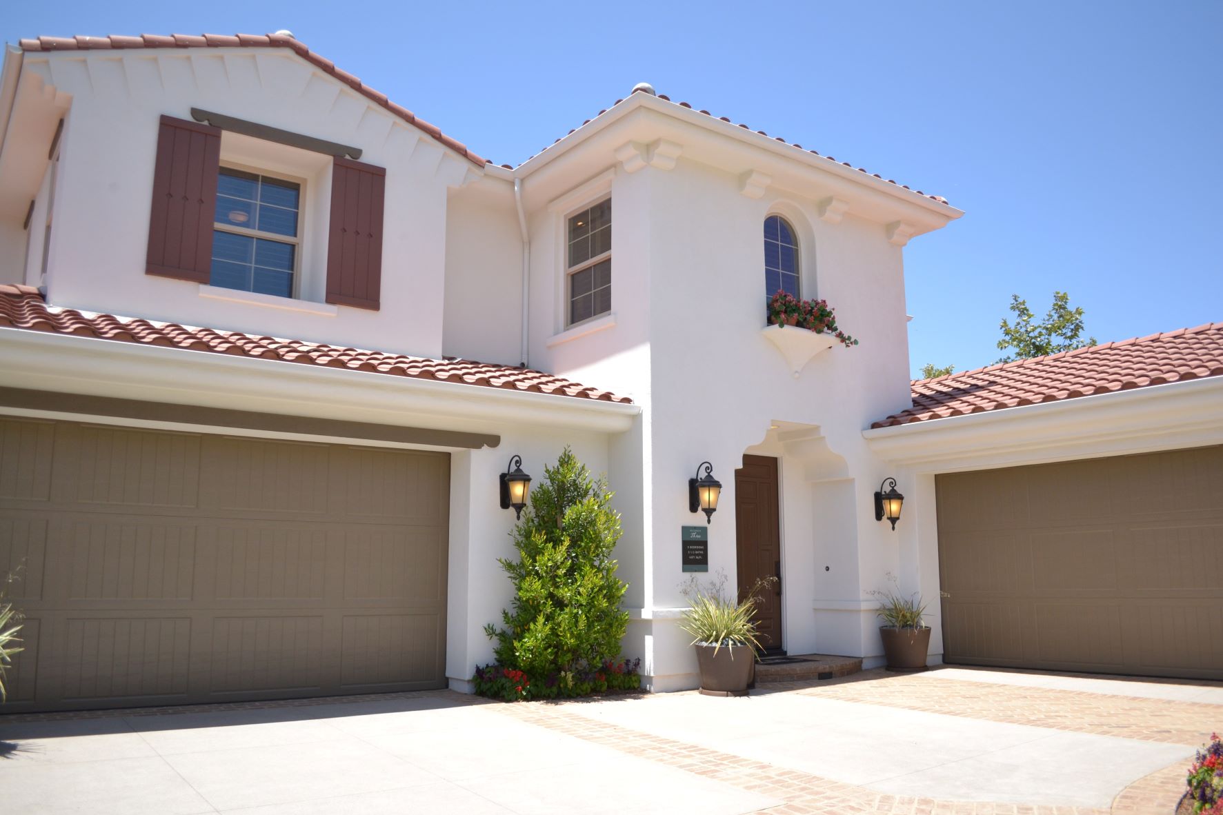 This is a picture of a white concrete two-story house.
