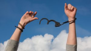 raised hand with handcuffs