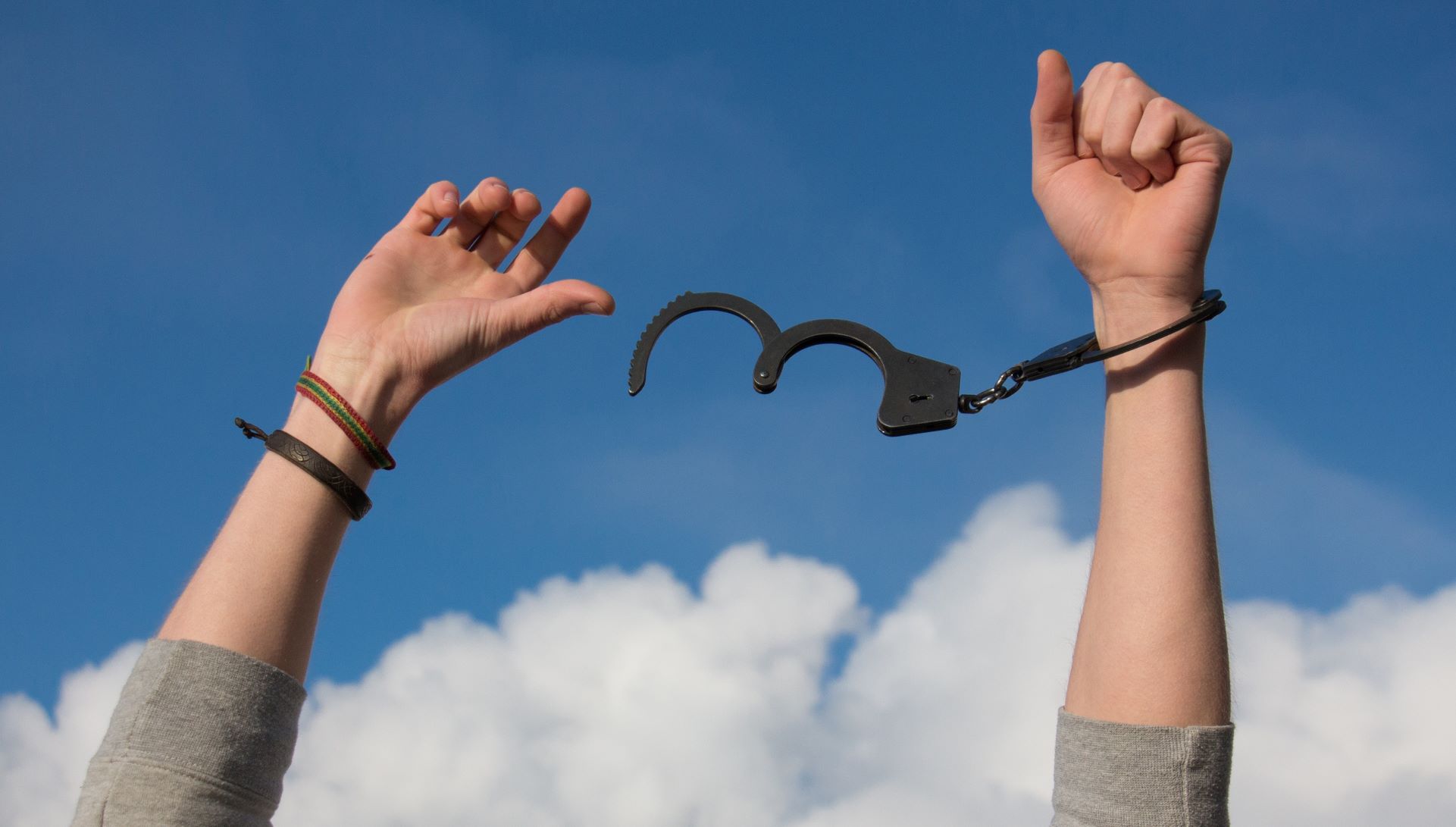 raised hand with handcuffs
