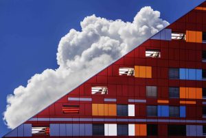 A cloud in the sky hovering behind the building.