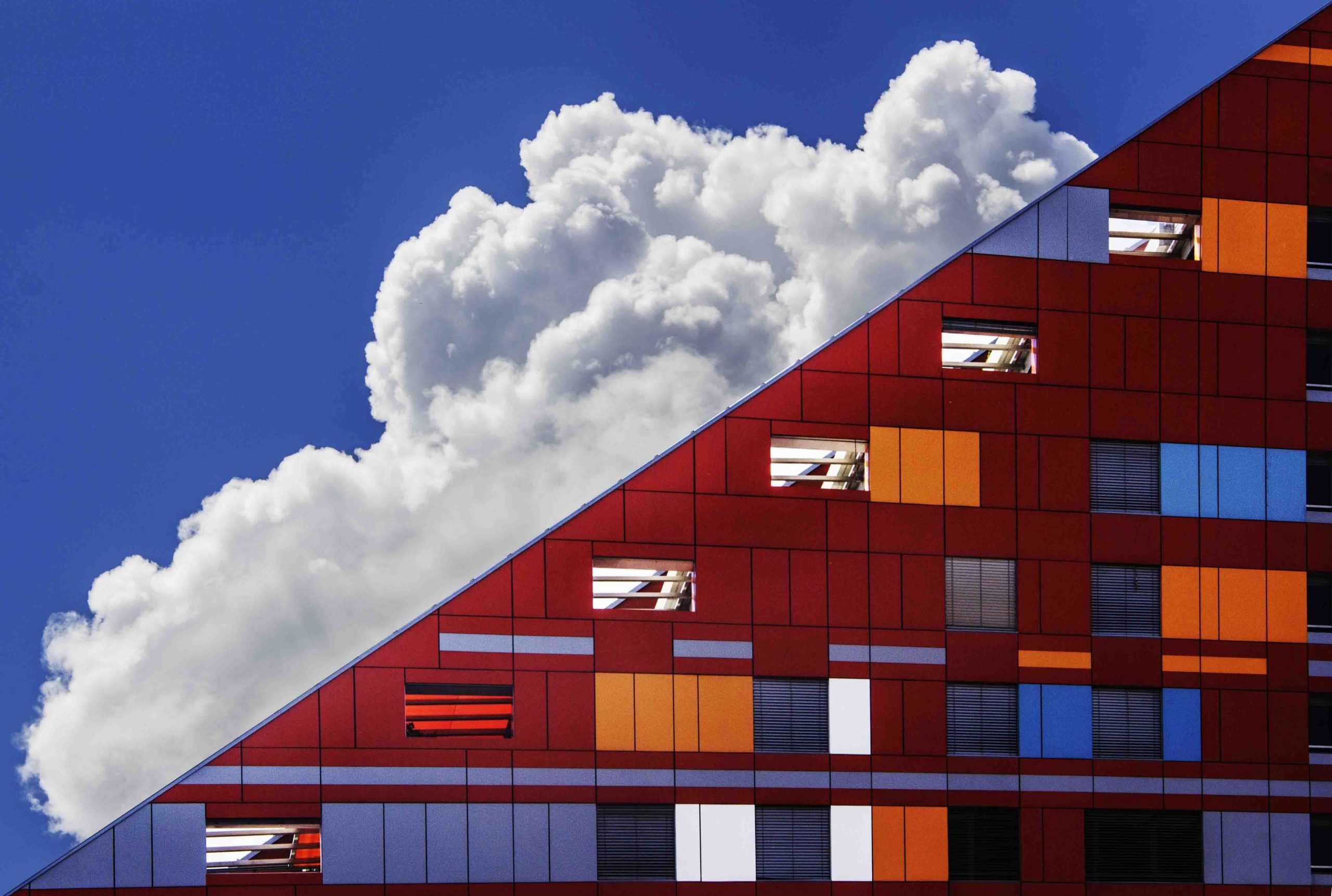 A cloud in the sky hovering behind the building.