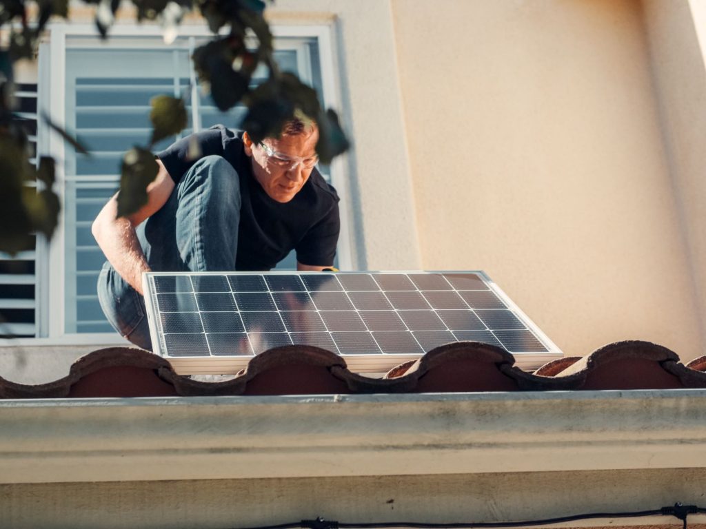 a photo of a man installing a solar panel Common Solar Panels