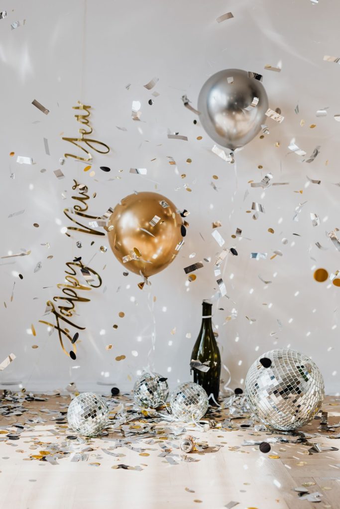 win bottle with ballons and confetti Holidays Past Debts