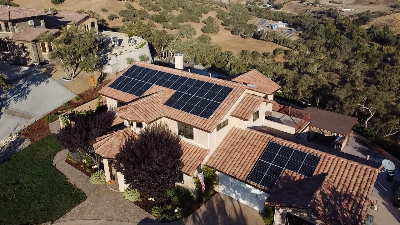 A residential property with solar technologies on its roof.