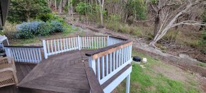 A picture of a wooden deck that also serves as a transitional lanai.
