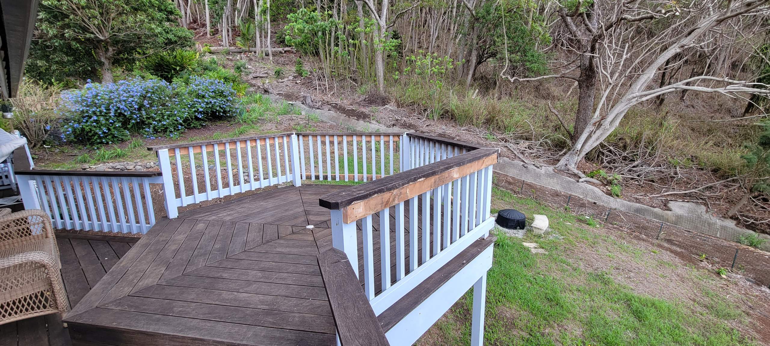 A picture of a wooden deck that also serves as a transitional lanai.