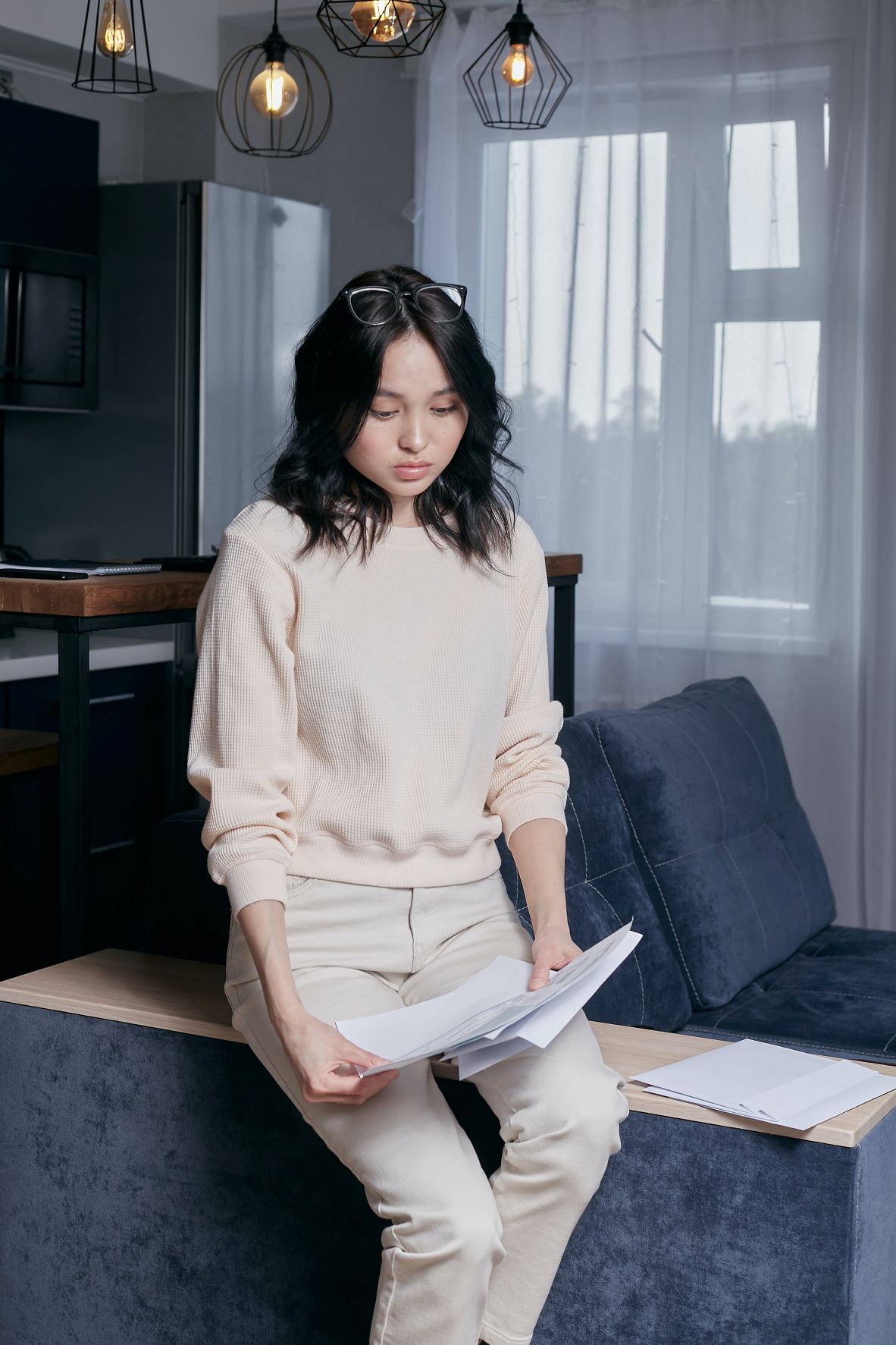 Reasons You May Still Be In Debt woman holding paper
