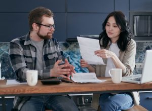 On Board With Paying Off Debt couple discussing debt