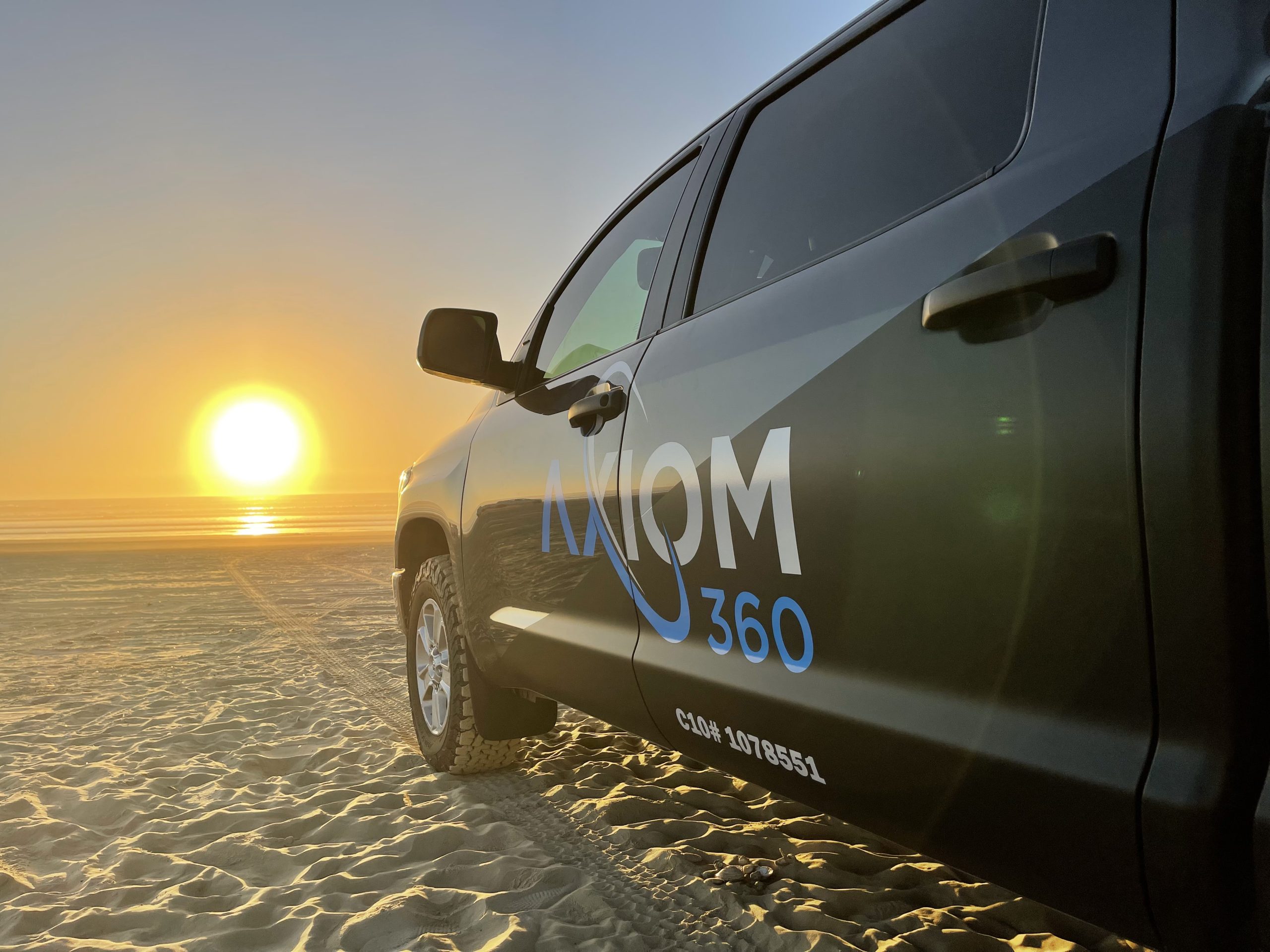Axiom 360 logo on the truck promoting responsible solar energy services.