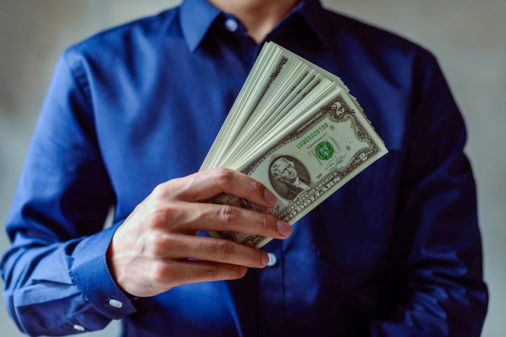 man holding money ways to earn interest