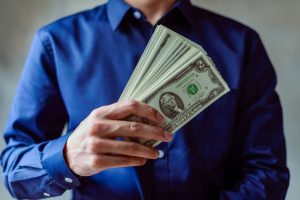 man holding money ways to earn interest