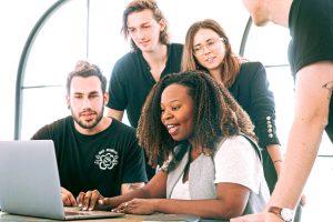 people in front of laptop how to use content marketing