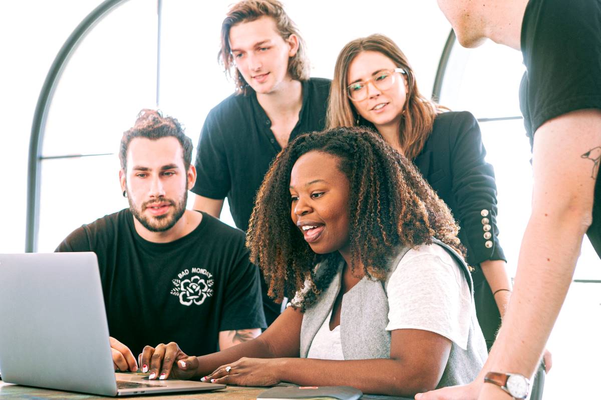 people in front of laptop how to use content marketing