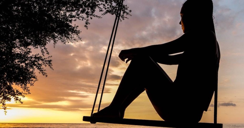 silhouette of woman sitting on swing benefits of looking inward and neuroplasticity