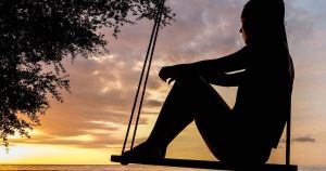 silhouette of woman sitting on swing benefits of looking inward and neuroplasticity