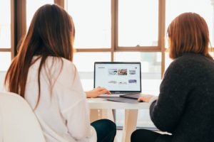 Two people outsourcing content marketing services for a business.