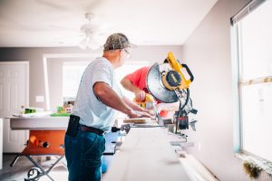 A man ensuring quality workmanship for home improvement services.