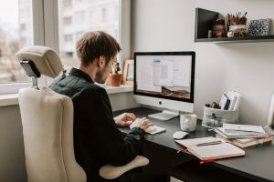 man typing on keyboard working on article discussing how lead generation helps with content