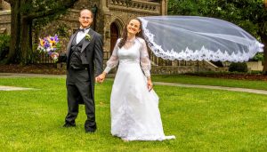 lovely picture of groom and bride with veil floating in the air showcasing the importance of wedding photography