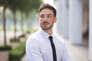 a photo of a young businessman which is an example of corporate headshots
