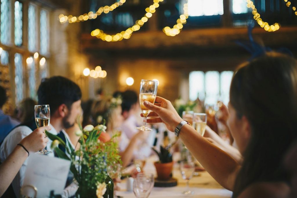 Photo of people raising their wine glass, satisfied with their catering service