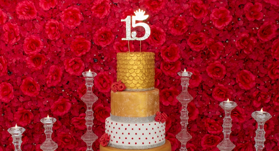 Photo of a cake with a number 15 candle on top, depicting the creative themes for your quinceañera photoshoot.